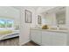 Bright bathroom with a double sink vanity, stone countertops, modern fixtures, and wood look floors at 1078 Clay Blvd, Tavares, FL 32778
