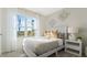 Cozy bedroom with a comfortable bed, a side table with lamp, and a bright window, creating a relaxing retreat at 1078 Clay Blvd, Tavares, FL 32778