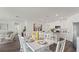 Bright dining area featuring a white table set for six, and an open view to the kitchen with stainless steel appliances at 1078 Clay Blvd, Tavares, FL 32778