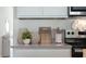 Cozy kitchen detail showcasing countertop decor, cutting boards, and modern stainless-steel appliances at 1078 Clay Blvd, Tavares, FL 32778
