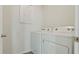 Convenient laundry room equipped with modern washer and dryer units, and decorative laundry themed wall art at 1078 Clay Blvd, Tavares, FL 32778