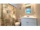 Well-maintained bathroom featuring a vanity, mirror, toilet, and shower with decorative curtain at 111 Palencia Rd, Auburndale, FL 33823