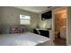 Inviting bedroom complemented by a TV, dresser, and an en-suite bathroom entrance at 111 Palencia Rd, Auburndale, FL 33823