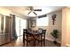 Dining area features a modern ceiling fan, dining table and new stainless steel refrigerator at 111 Palencia Rd, Auburndale, FL 33823