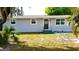 Well-maintained single story home with light grey siding, small porch, and lush green lawn at 111 Palencia Rd, Auburndale, FL 33823