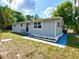 Inviting single story house featuring a manicured lawn, crisp white trim and a walkway at 111 Palencia Rd, Auburndale, FL 33823