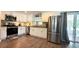 Modern kitchen featuring stainless steel appliances, granite countertops, and ample cabinet space at 111 Palencia Rd, Auburndale, FL 33823