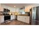 Modern kitchen featuring stainless steel appliances, granite countertops, and white cabinetry at 111 Palencia Rd, Auburndale, FL 33823