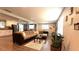 Open living space featuring hardwood floors, a comfortable sectional couch and natural light at 111 Palencia Rd, Auburndale, FL 33823