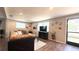 Cozy living room with hardwood floors, a comfortable sectional couch, and a wall-mounted television at 111 Palencia Rd, Auburndale, FL 33823