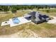 Aerial view of home with solar panels, screened pool, and outdoor living space at 11400 Lovers Ln, Winter Garden, FL 34787