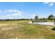 Expansive grassy backyard with a fenced pool area and an open view of the surrounding landscape at 11400 Lovers Ln, Winter Garden, FL 34787