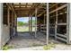 Barn interior with wooden stalls, providing a safe and secure space for animals at 11400 Lovers Ln, Winter Garden, FL 34787