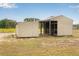 Outdoor barn structure featuring sheltered stalls and potential storage space at 11400 Lovers Ln, Winter Garden, FL 34787