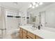 Bathroom featuring a double sink vanity, a shower-tub combination and a glass block window at 11400 Lovers Ln, Winter Garden, FL 34787