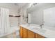 Bathroom with a double sink vanity and a shower-tub combination with white tiling at 11400 Lovers Ln, Winter Garden, FL 34787