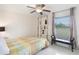 Bedroom with ceiling fan, decorative shelving, and bench seat near the window at 11400 Lovers Ln, Winter Garden, FL 34787