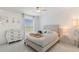 Cozy bedroom features a patterned dresser, a plush bed and a bright window at 11400 Lovers Ln, Winter Garden, FL 34787