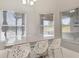 Bright dining area offering views of the backyard through large windows with modern chairs at 11400 Lovers Ln, Winter Garden, FL 34787