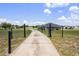 Long driveway leads to a beautifully maintained home with a spacious yard and secure fencing at 11400 Lovers Ln, Winter Garden, FL 34787