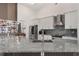 Open kitchen features granite countertops, stainless appliances, and elegant white cabinetry at 11400 Lovers Ln, Winter Garden, FL 34787