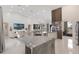 Open living area with a stone kitchen island, connecting the dining and living spaces for fluid entertaining at 11400 Lovers Ln, Winter Garden, FL 34787