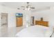 Bright main bedroom featuring neutral tones, large windows, and television set at 11400 Lovers Ln, Winter Garden, FL 34787