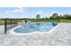 Beautiful in-ground pool with a pristine deck, secured by a sleek black fence for safety at 11400 Lovers Ln, Winter Garden, FL 34787