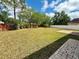 Spacious backyard with lush lawn, privacy fence, swing set and brick paver patio at 12101 Kendra Ct, Orlando, FL 32824