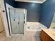 Elegant bathroom featuring a glass shower, soaking tub and vanity with attractive accents at 12101 Kendra Ct, Orlando, FL 32824