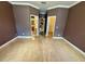 Spacious bedroom with hardwood flooring, a walk-in closet and a view of the bathroom at 12101 Kendra Ct, Orlando, FL 32824