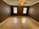 Spacious bedroom features two windows and hardwood floors at 12101 Kendra Ct, Orlando, FL 32824