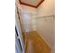 Walk-in closet with built-in shelving and wood floors at 12101 Kendra Ct, Orlando, FL 32824