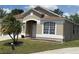 Inviting home exterior featuring a well-kept lawn and front entrance at 12101 Kendra Ct, Orlando, FL 32824