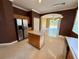Modern kitchen with stainless steel fridge, island, and tile floors at 12101 Kendra Ct, Orlando, FL 32824