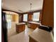 Open kitchen featuring an island, tile floors, and modern appliances at 12101 Kendra Ct, Orlando, FL 32824