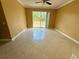 Bright living room with tile floors and sliding glass doors leading to the backyard at 12101 Kendra Ct, Orlando, FL 32824
