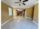Open-concept living room with tile flooring and archway view into the kitchen at 12101 Kendra Ct, Orlando, FL 32824