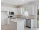 Modern kitchen features white cabinets, an island, and stainless steel appliances at 1263 Stockwell Ave, St Cloud, FL 34771