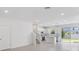 Well-lit living room features tile floors, recessed lighting, staircase, and an adjacent kitchen at 1263 Stockwell Ave, St Cloud, FL 34771