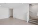 Well-lit living room with tile floors, stairs, and white walls at 1263 Stockwell Ave, St Cloud, FL 34771