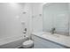 Clean bathroom with a shower-tub combination, white subway tile, and sleek vanity with a marble countertop at 13540 Autumn Harvest Ave, Winter Garden, FL 34787