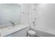 Clean bathroom with a shower-tub combination, white subway tile, and sleek vanity with a marble countertop at 13540 Autumn Harvest Ave, Winter Garden, FL 34787