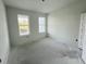 Spacious bedroom illuminated by natural light from two windows, offering a cozy and inviting atmosphere at 13540 Autumn Harvest Ave, Winter Garden, FL 34787