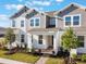 Beautiful townhome boasting gray siding, manicured landscaping, and a welcoming front entrance at 13540 Autumn Harvest Ave, Winter Garden, FL 34787