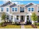 Charming townhome featuring a manicured lawn, gray siding, and inviting covered entry at 13540 Autumn Harvest Ave, Winter Garden, FL 34787