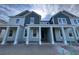 Charming exterior elevation showcasing a modern two-story home with a welcoming front porch and neutral color palette at 13540 Autumn Harvest Ave, Winter Garden, FL 34787