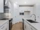 Contemporary kitchen showcasing quartz countertops, stainless steel appliances, and sleek cabinetry at 13540 Autumn Harvest Ave, Winter Garden, FL 34787