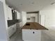 Bright kitchen featuring a large center island, ample cabinet space, and contemporary finishes throughout at 13540 Autumn Harvest Ave, Winter Garden, FL 34787