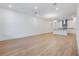 Spacious living room with wood flooring and abundant natural light, adjacent to modern kitchen at 13540 Autumn Harvest Ave, Winter Garden, FL 34787